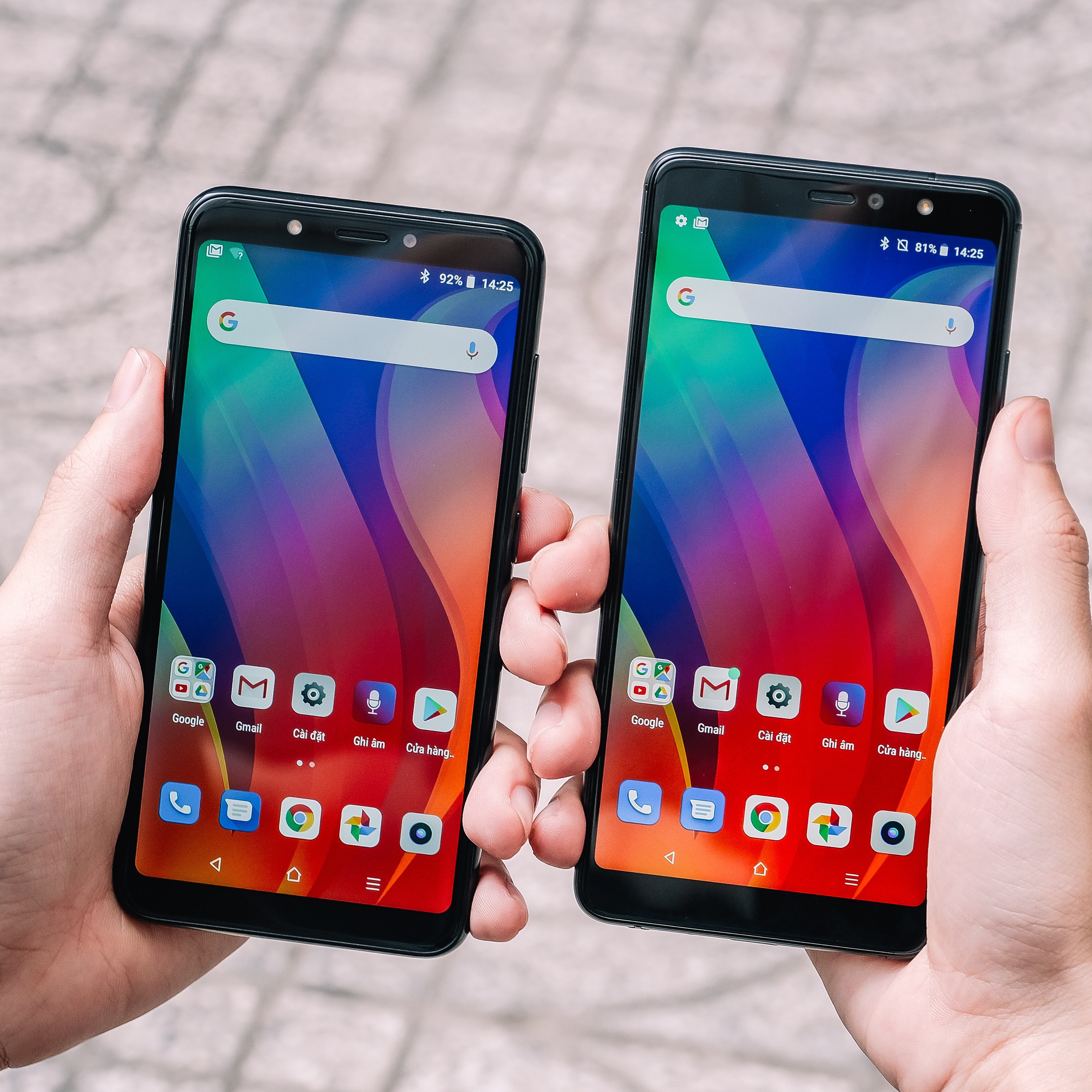 two hands each holding an Android phone